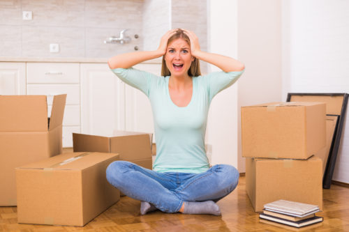 Woman screaming in panic because of too much things to do while moving into new home.