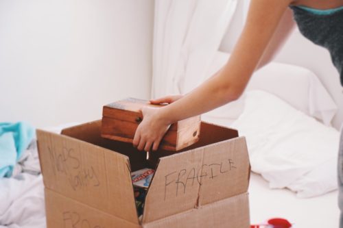 girl packing a box for moving