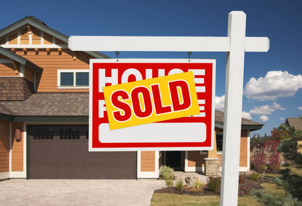 A home with a sold sign outside